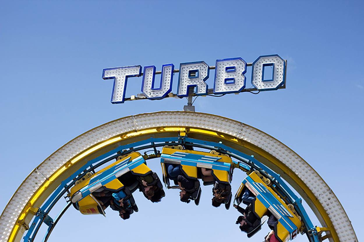 A picture of a looping on a roller coaster ride with a big sign reading Turbo