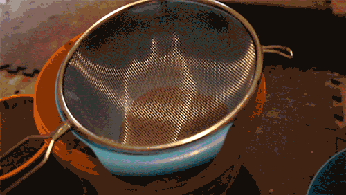 shaking the sieve to filter the dirt