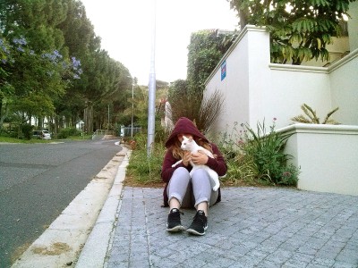 Cuddling the Cat in cape town sitting on the street